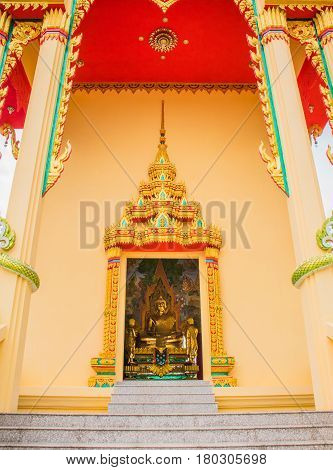 buddha statue view through the door of temple. Generality in Thailand any kind of art decorated in Buddhist church temple pavilion temple hall monk's house etc. created with money donated by people to hire artist. They are public domain or treasure of Bud