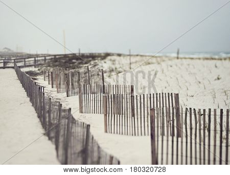 Beautiful beach on a stormy day in Florida on the Gulf of Mexico with sand fences to prevent erosion.