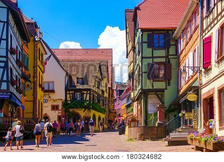 Riquewihr France-June 23 2016: Tourists are walking on the main shopping street; Rue du General de Gaulle in Riquewihr Alsace wine road