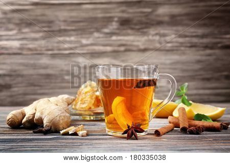 Hot drink with honey and lemon for cough remedy on wooden table