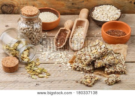Healthy Snack - Crispy Cereal Cookies On Old Wooden Table And Ingredients: Oat Flakes, Flax Seed, Pu
