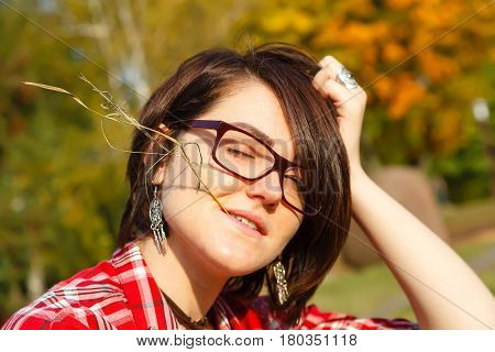 A rural girl with a blade of grass in her mouth