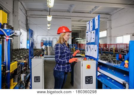 Woman In Red Safety Helmet Work As Industrial Worker