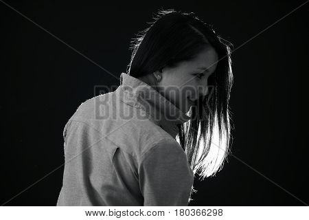 Сloseup Black and white portrait of a dark haired beautiful stylish young model in a shirt on a black background with different emotions smiling