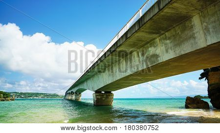 Sightseeing View of The Kouri Bridge with blue sky one of the very long bridge in Okinawa Japan.