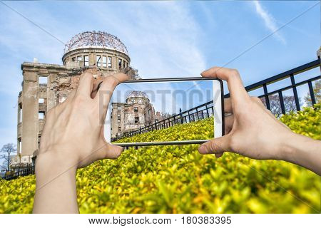 Tourist using smartphone taking a photo of  Atomic Bomb in Hiroshima, Japan