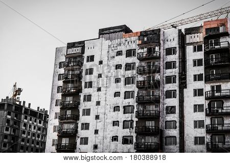 Building under construction. Apartment buildings. Construction crane. High-rise building. Multistory building