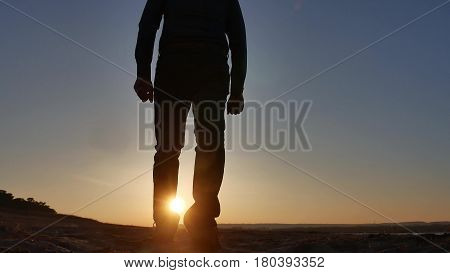 freedom. Man stands on cliff sunset silhouette hand lifestyle in the sides