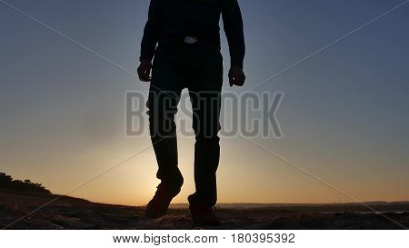 freedom. Man stands on cliff sunset silhouette hand lifestyle in the sides