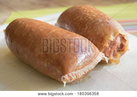 Italian cotechino or gelatinous pork sausage in a natural casing