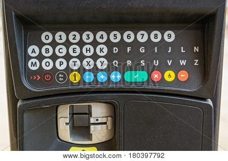Close up of parking meter with colorful buttons in the street