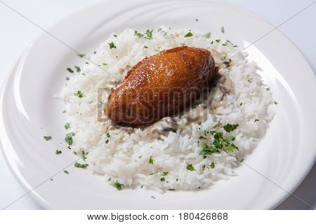 Cordon Bleu With Rice On A White Plate