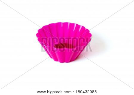 Bright pink silicone baking case for cupcakes on white background