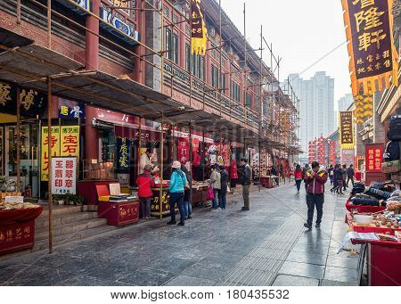 Tianjin, China - Nov 1, 2016: Tianjin Ancient Cultural Street; shop buildings preserved in the classical Qing Dynasty architectural style. Morning scene to what is a very popular tourist area.