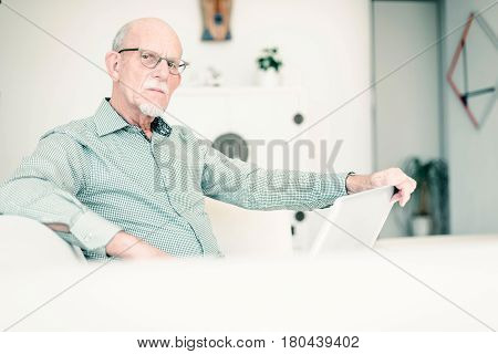 Senior Man With Laptop On Couch At Home.