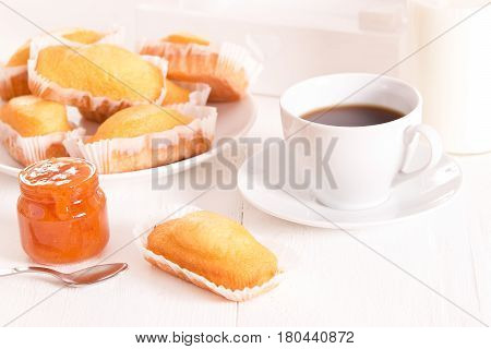 Breakfast with plumcake and cup coffee on wooden table.