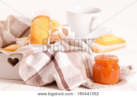 Breakfast with plumcake and cup coffee on wooden table.