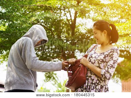 Asian woman being attack by snatch thieft