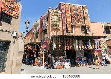 MARRAKESH MOROCCO - APR 29 2016: Tourist shops with traditional moroccan textile for sale in the souks of Marrakech.