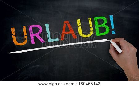 Urlaub (in German Holiday) Is Written By Hand On Blackboard