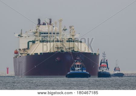 GAS CARRIER - Tanker entering the port by tugboats assisted on a rope