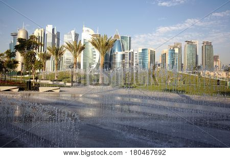 DOHA, QATAR - FEBRUARY 17, 2016: The high-rise district of Doha, seen from the recently completed Hotel Park, with fountains in the foreground
