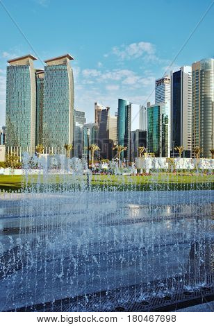 DOHA, QATAR - FEBRUARY 17, 2016: The high-rise district of Doha, seen from the recently completed Hotel Park, with fountains in the foreground