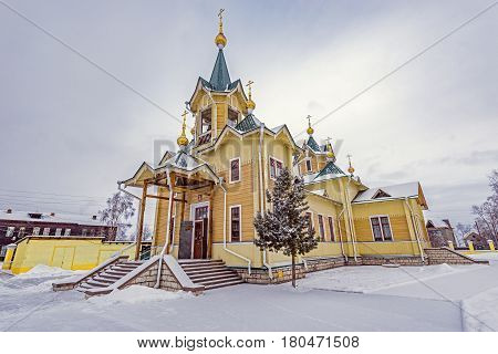 The wooden church of St. Nicholas at winter day time. Church was founded at the beginning of the 20th century. Slyudyanka. Russia.
