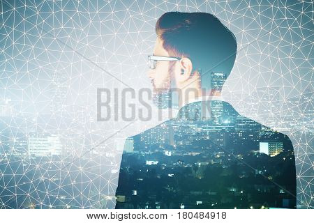 Back view of thoughtful young businessman on abstract polygonal night city background. Future concept. Double exposure