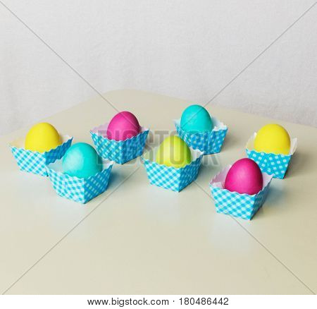 Painted  in different colors  Easter eggs on light background.
