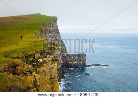 Beautiful vibrant view of the edge of the world, westernmost point in Europe, Iceland, Latrabjarg, looking like faroe islands, Moher Cliffs with atlantic puffins and other birds