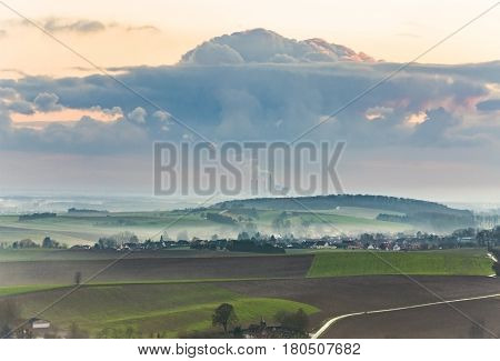 Landscape With Freshly Plowed Acre And Green Plants