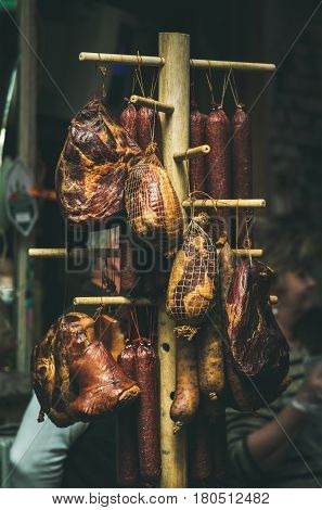 BUDAPEST, HUNGARY - MARCH 26, 2017: Variety of traditional Hungarian smoked meat and sausages hanging on Sunday farmers' market at Szimpla Kert ruin pub in Jewish quarter of Budapest