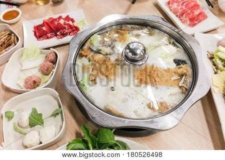 Traditional Chinese Steamboat Or Hotpot With Delicious Food Spread