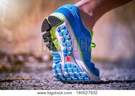 Running athlete during training outdoors in the summer on a sunny day.