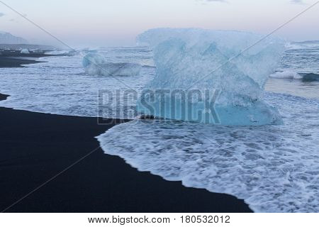 Natural black sand beach with Ice breaking on top Iceland natural winter season landscape background