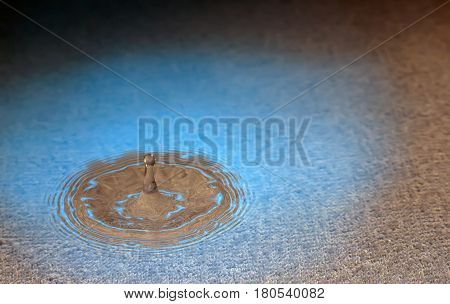stiffened water drop falling on a water surface,Blue and brown tones