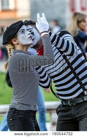 TIMISOARA ROMANIA - MARCH 31 2017: Pantomime couple with painted face present on the street inside the CheckART Carnival organized by the City Hall Timisoara. Union Square.