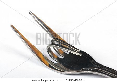 Bent metal fork in a Heavy metal or rock sign, close-up