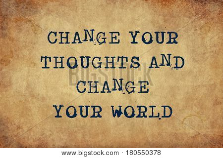 Inspiring motivation quote with typewriter text change your thoughts and change your world. Distressed Old Paper with Typing image.
