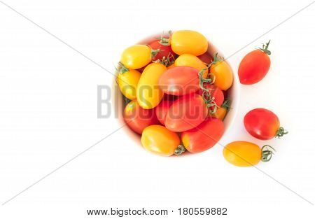 Top view fresh cherry tomatoes in bowl on white background