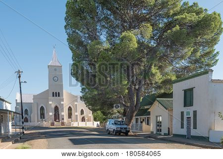 PHILIPPOLIS SOUTH AFRICA - MARCH 21 2017: A street scene with the Dutch Reformed Church and historic buildings in Philippolis the oldest town in the Free State Province