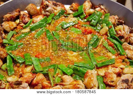Paella from Spain recipe process ad vegetables green beans and tomato