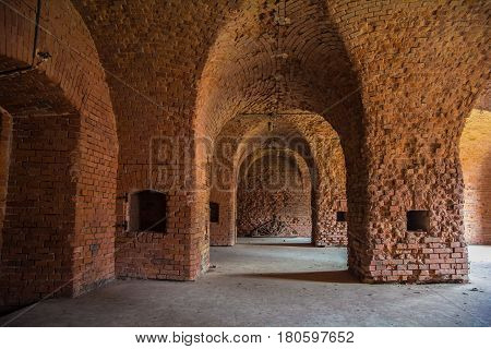 Arched corridors of the old fortification structure of red brick