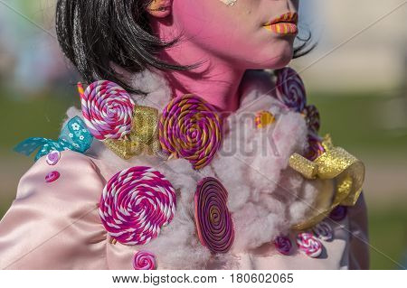 TIMISOARA ROMANIA - MARCH 31 2017: Detail of one living statue of a woman multicolor dressed and present on the street inside the CheckART Carnival organized by the City Hall Timisoara. Union Square