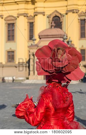TIMISOARA ROMANIA - MARCH 31 2017: Detail of one living statue of a woman multicolor dressed and present on the street inside the CheckART Carnival organized by the City Hall Timisoara. Union Square