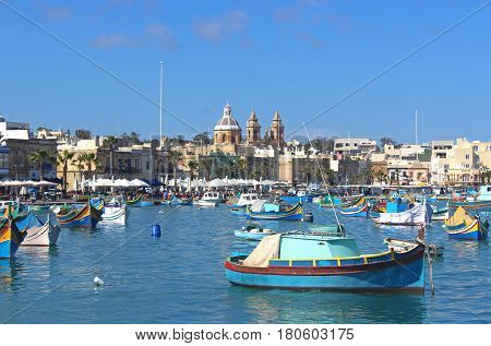 colorful fishing boats in the harbor of Marsaxlokk Malta