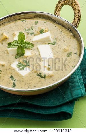 methi malai paneer or Creamy Fenugreek & Paneer Curry, popular north indian recipe prepared using milk cream, methi and paneer or cottage cheese, served with roti/paratha, selective focus