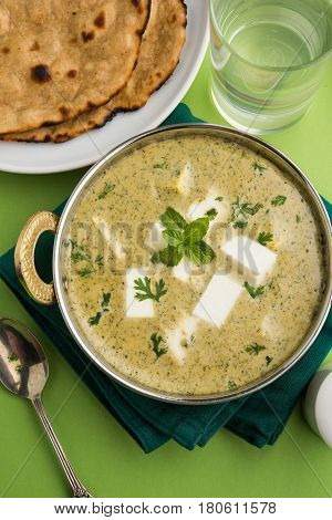 methi malai paneer or Creamy Fenugreek & Paneer Curry, popular north indian recipe prepared using milk cream, methi and paneer or cottage cheese, served with roti/paratha, selective focus
