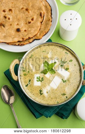methi malai paneer or Creamy Fenugreek & Paneer Curry, popular north indian recipe prepared using milk cream, methi and paneer or cottage cheese, served with roti/paratha, selective focus